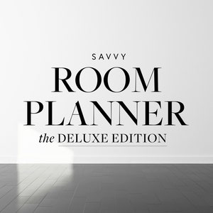 May include: A white wall with the text "SAVVY ROOM PLANNER the DELUXE EDITION" in black. A black and white logo with the text "THE SAVVY HEART" is on the floor.