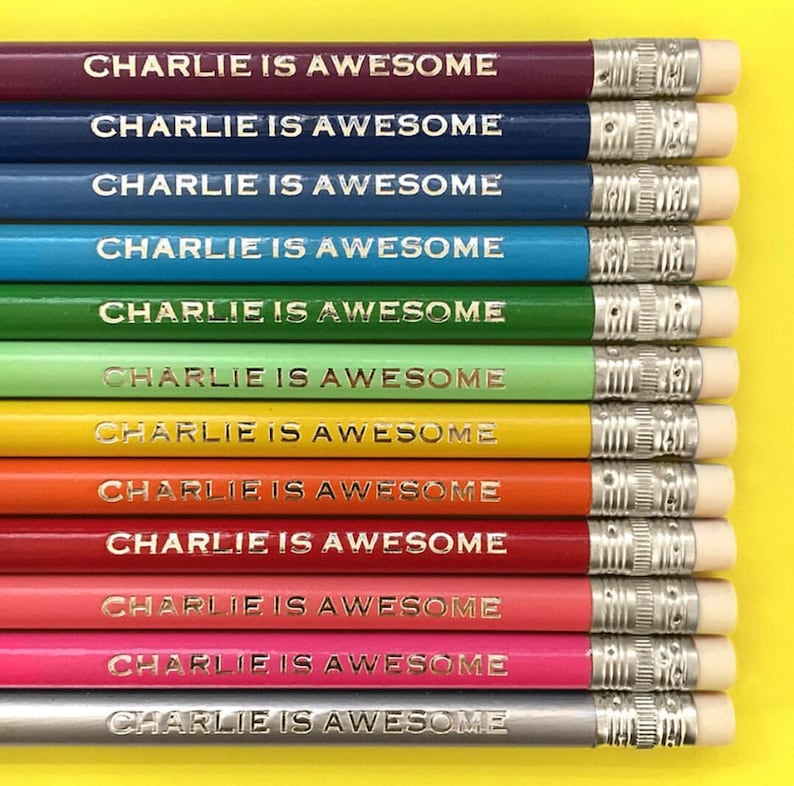 May include: A set of 12 pencils with a rainbow of colors. Each pencil has the words "CHARLIE IS AWESOME" printed in gold on the side.