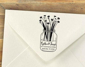 May include: A black and white illustration of a mason jar filled with wildflowers. The text "Cynthia & Joseph", "211 Commerce Street", "Nashville, TN 37201" is printed below the jar.