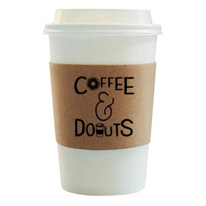 May include: White takeaway coffee cup with a brown paper sleeve that says "COFFEE & DONUTS" with a donut and coffee cup graphic.