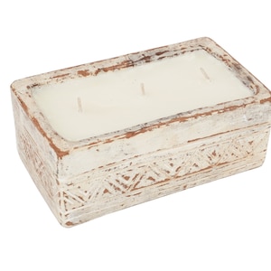 May include: White rectangular candle holder with a carved design. The holder is made of ceramic and has three wicks.