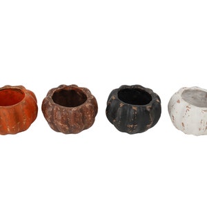 May include: Four small pumpkin-shaped ceramic planters in orange, brown, black, and white. The planters have a rustic, distressed finish.