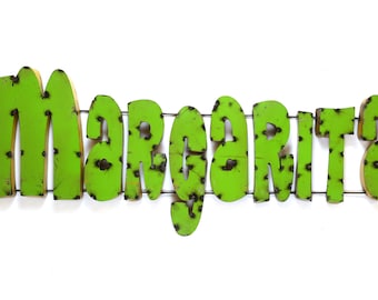 May include: Green metal sign with the word "Margarita" in a rustic, distressed style.