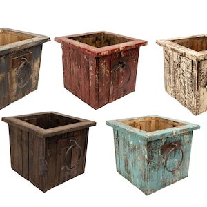 May include: Set of five square wooden planter boxes with metal ring handles. The boxes are in various colors, including black, red, white, brown, and blue. Each box has a distressed, rustic look.