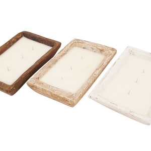 May include: Three wooden dough bowl candles in different shades of brown, beige, and white. Each candle has three wicks and is made of white wax.