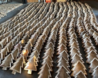 May include: A large collection of wooden Christmas tree-shaped bowls arranged in rows. The bowls are made of natural wood and have a rustic, handcrafted look.