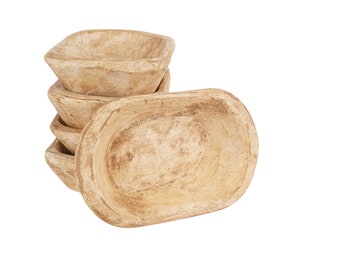 May include: A stack of four wooden bowls, all with a light brown color and a slightly distressed finish. The bowls are stacked in a staggered pattern, with the largest bowl on the bottom and the smallest bowl on top.