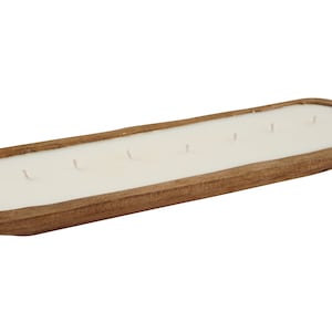 May include: A long, wooden candle tray with a white candle inside. The tray is made of natural wood and has a rustic look.