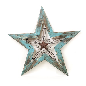 May include: A large, rustic, teal blue wooden star with a metal star design in the center. The metal star is brown and has a swirl design.