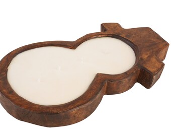 May include: A wooden snowman candle holder with a white candle inside. The holder is made of dark brown wood and has a rustic look.