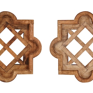 May include: Set of four decorative wooden wall decor pieces. Each piece features a square frame with a diamond-shaped lattice design. The frames are painted in various colors, including blue, brown, and white.