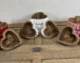 May include: Set of three wooden heart-shaped bowls, each painted in a different colour: red, white, and pink. The bowls are stacked on top of each other.