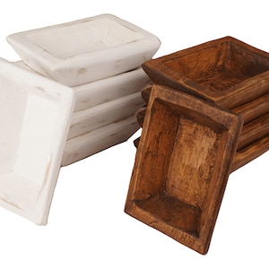 May include: A set of six wooden bowls, three are white and three are brown. The bowls are stacked on top of each other.