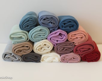 May include: A stack of 14 rolled fabric swatches in various colors, including blue, green, pink, and brown. The fabric is soft and appears to be made of a lightweight material.