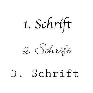 May include: Three examples of the word "Schrift" written in different fonts. The first is in a cursive font, the second is in a more decorative cursive font, and the third is in a simple, sans-serif font.