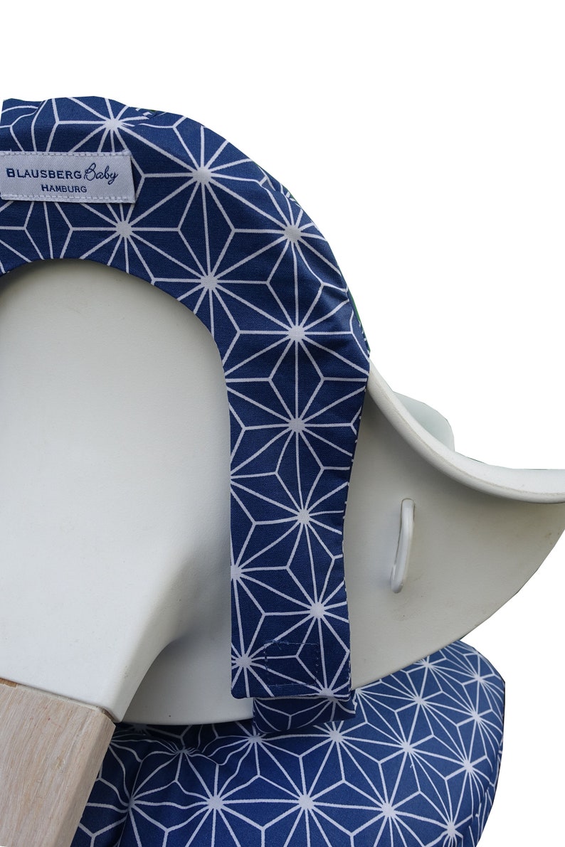 May include: A blue and white geometric patterned high chair cover with the text "Blausberg Baby Hamburg" on the top.