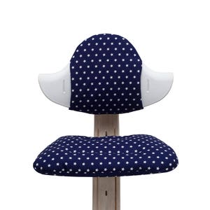 May include: A white and blue chair with a star pattern on the seat and back. The chair has a white, curved back and a white base.