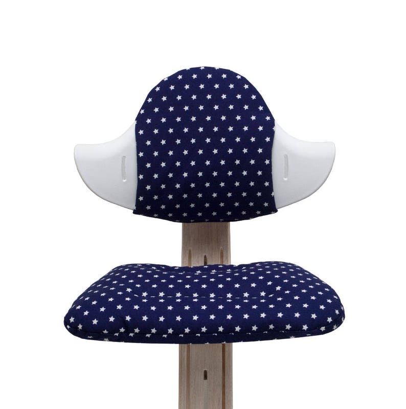 May include: A white and blue chair with a star pattern on the seat and back. The chair has a white, curved back and a white base.
