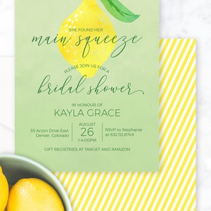May include: A green and yellow bridal shower invitation with a watercolor illustration of a lemon. The invitation reads "She found her main squeeze" and "Please join us for a bridal shower in honour of Kayla Grace". The date is August 26th at 1:00 PM. The location is 35 Acton Drive East, Denver, Colorado. The RSVP information is to Stephanie at 632.112.8749. The invitation also states "Gift registries at Target and Amazon".
