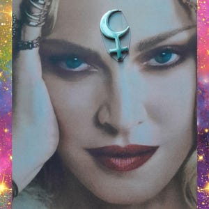 May include: A silver-toned pendant in the shape of a crescent moon and a cross, placed on a woman's forehead. The image features a woman with blue eyes and red lipstick. Text includes "Wild Bohemian Rose etsy" and "Always purchase where you see my name on photo."