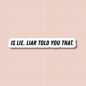 May include: A white sticker with black text that reads "IS LIE. LIAR TOLD YOU THAT." The sticker has a white border and is set against a pink grid background.