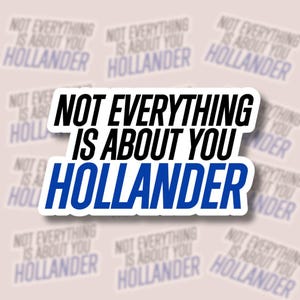 May include: A white sticker with the text "NOT EVERYTHING IS ABOUT YOU HOLLANDER" in black and blue. The sticker has a white border and is surrounded by other stickers with the same text.