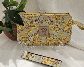 Wristlet/key fob set, a stunning entry to spring with soft yellow flowers and honeycomb pattern lining the color of cabernet