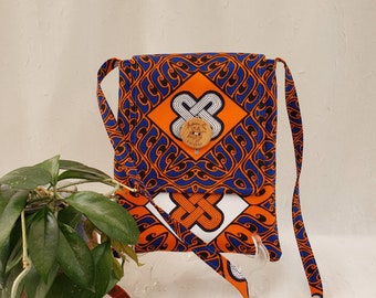 Crossbody cotton bag. African design in bright orange & royal blue w/ orange accents and lining, 2 inside pockets, button closure, 51" strap