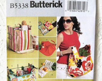 May include: A sewing pattern for making reusable shopping bags. The pattern includes instructions for making a variety of bags, including a tote bag, a market bag, and a cooler bag. The pattern is from Butterick and has the number B5338/OSZ.