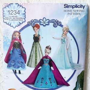 May include: A Simplicity sewing pattern for 11 1/2 inch doll clothes featuring Disney's Frozen characters. The pattern includes four different outfits: a blue dress with a red cape, a green dress with a black bodice, a blue dress with a purple cape, and a light blue dress with a white cape. The pattern is labeled "1234" and "OS" for one size.