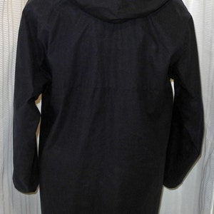 May include: A black hooded jacket with long sleeves and a zipper closure.