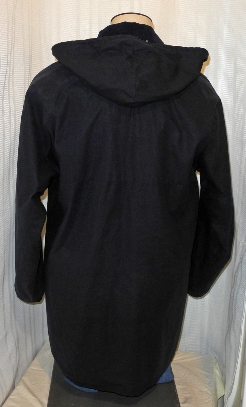 May include: A black hooded jacket with long sleeves and a zipper closure.