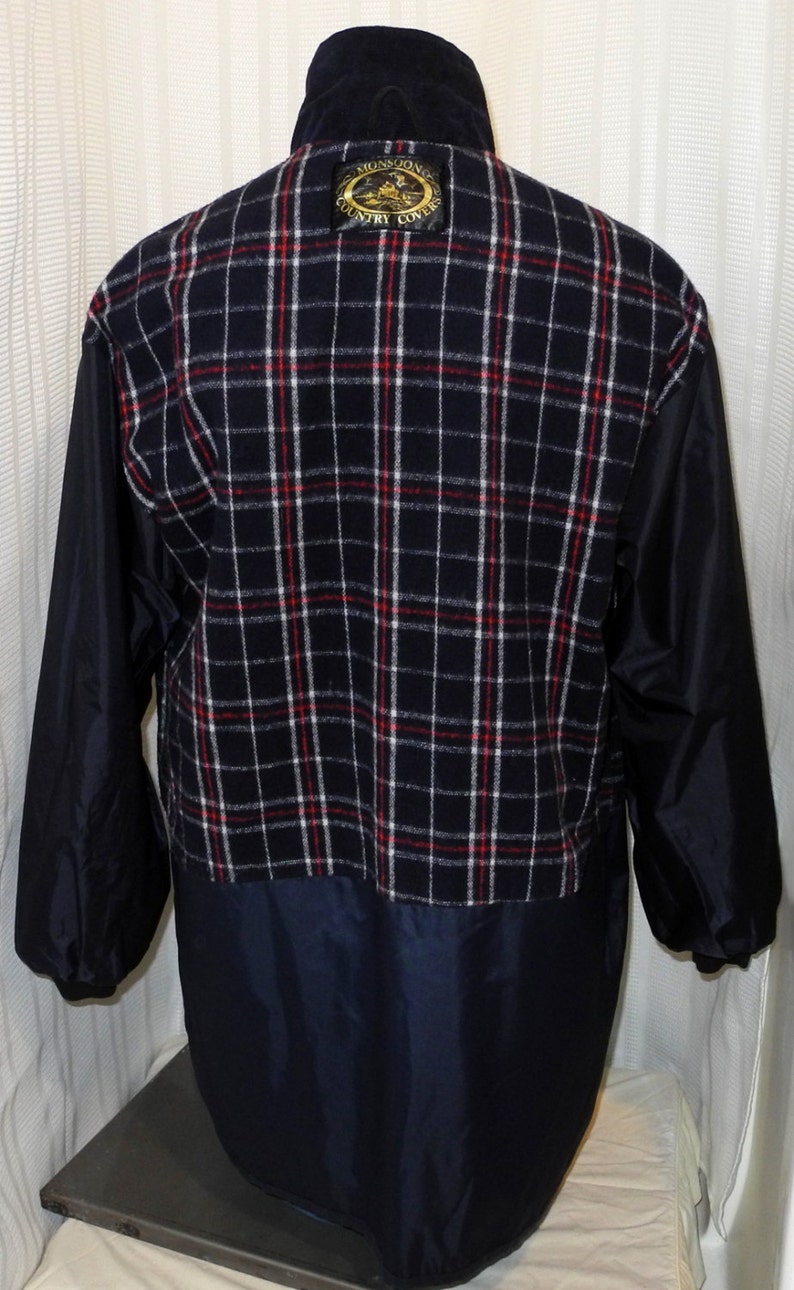 May include: A navy blue jacket with a plaid fleece lining and a black patch on the back that says "Monsoon Country Covers".