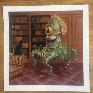 May include: A green, one-eyed monster with a spiral ear stands in a room with a bookshelf and a brown leather armchair. A black cat sits on the armchair. The monster has a toothy grin and is wearing a striped pattern.