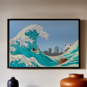 May include: A framed print of a blue and green wave with a person riding a surfboard. The wave is crashing over a small island with a white building on it. The print is hanging on a light beige wall above a wooden shelf.