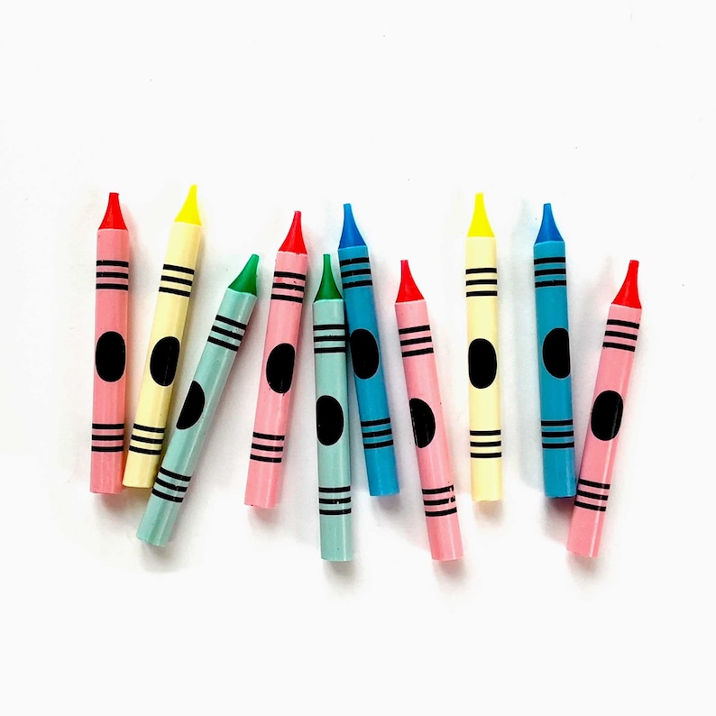 May include: A collection of ten crayons in various colors, including red, blue, green, yellow, and pink. Each crayon has a black circle at the end.