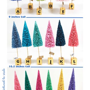 May include: A collection of eighteen decorative bottle brush trees in various colors, each mounted on a gold-painted square base. The trees are labeled A through R, with heights of 9 inches, 10.5 inches, and 11 inches indicated for each row.