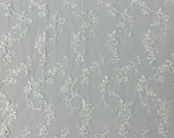 White flower lace corded and embroider with sequins on a mesh-Sold by the yard.