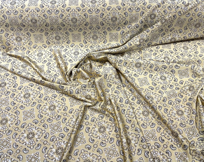 Light Gold metallic bandanna print on a stretch tricot spandex fabric- Sold by the yard.