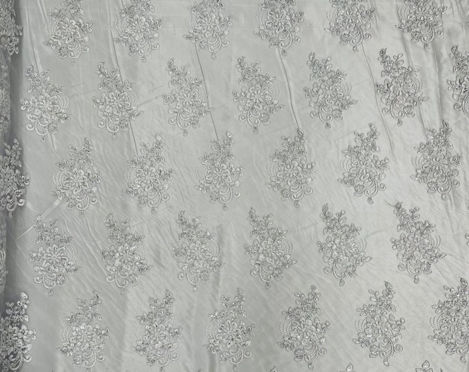 White silver corded embroider flowers with sequins on a mesh lace fabric-prom-sold by the yard.