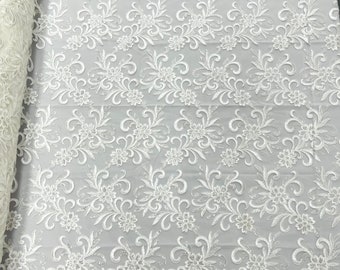 Ivory corded flowers embroider with sequins on a mesh lace fabric-sold by the yard-