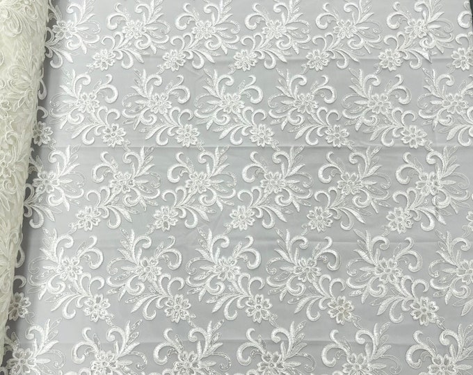 Ivory corded flowers embroider with sequins on a mesh lace fabric-sold by the yard-