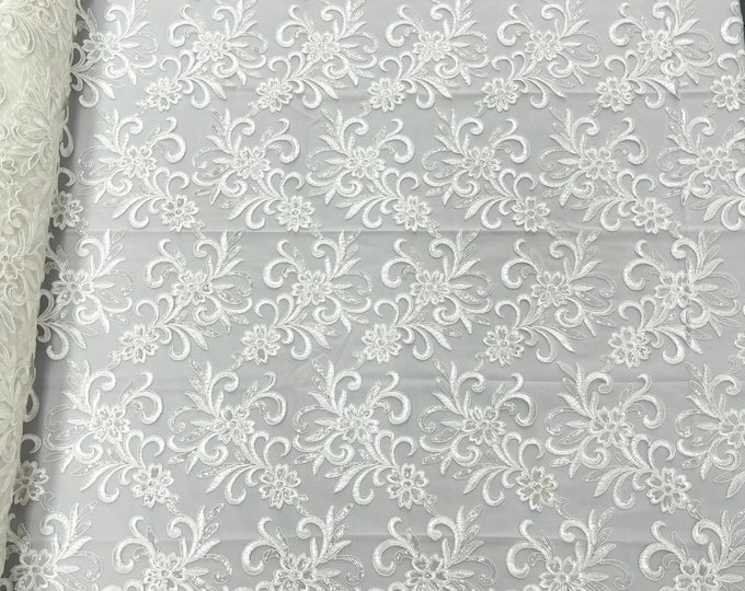 Ivory corded flowers embroider with sequins on a mesh lace fabric-sold by the yard-
