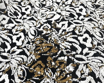 White, gold sequins flip two tone floral design on a black stretch velvet, Sold by the yard.