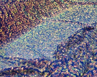 Aqua Clear iridescent mini round paillette sequins embroidered on a royal blue stretch mesh, sold by the yard.