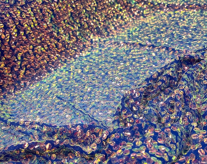 Aqua Clear iridescent mini round paillette sequins embroidered on a royal blue stretch mesh, sold by the yard.