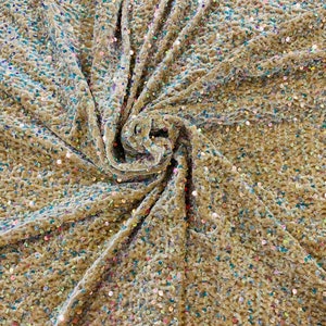 Clear Iridescent economic all over shiny sequins on a 2 way stretch Gold velvet , sold by the yard.