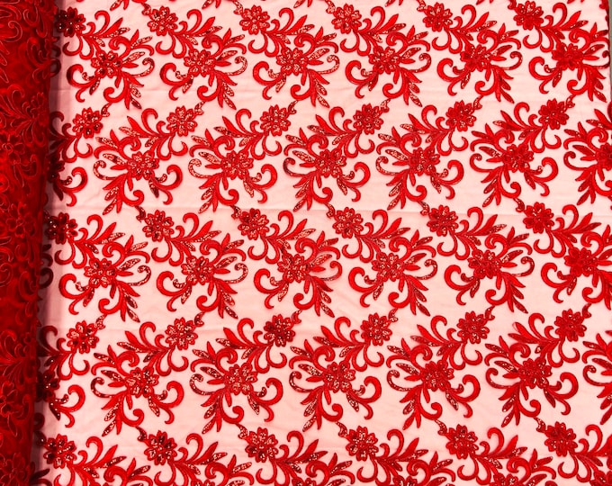 Red corded flowers embroider with sequins on a mesh lace fabric-sold by the yard-