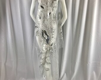 White peacock feathers embroider with shiny silver sequins on a white mesh-apparel-fashion-decorations-dresses-nightgown-sold by 2 panels.