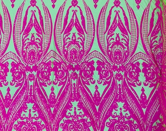 Hot pink empire damask design with sequins embroider on a neon green  4 way stretch mesh fabric-sold by the yard.